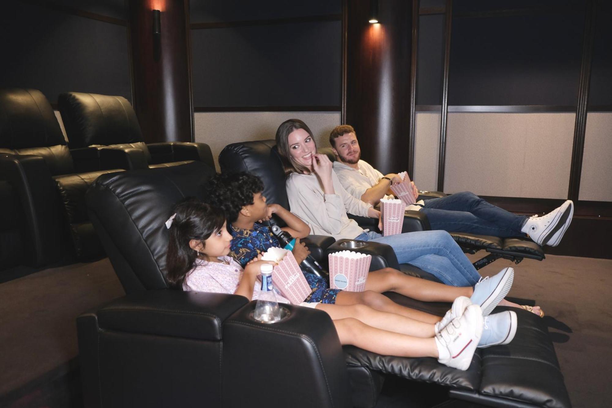 麦纳麦 Charthouse Bahrain酒店 外观 照片 A family watching a movie in a home theater